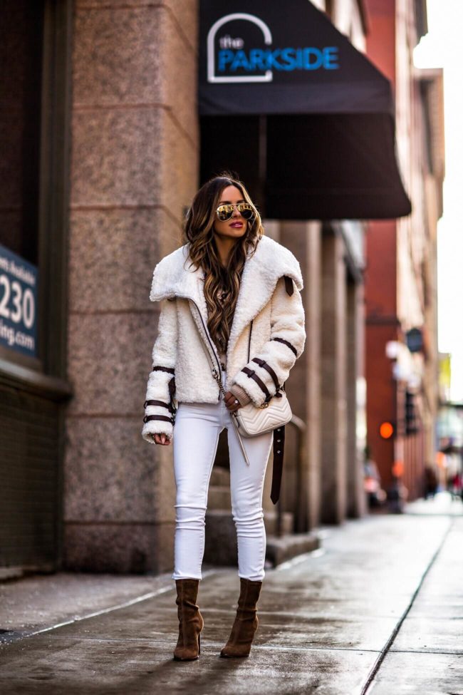 fashion blogger mia mia mine wearing a white sherpa jacket and brown suede booties by alexander wang