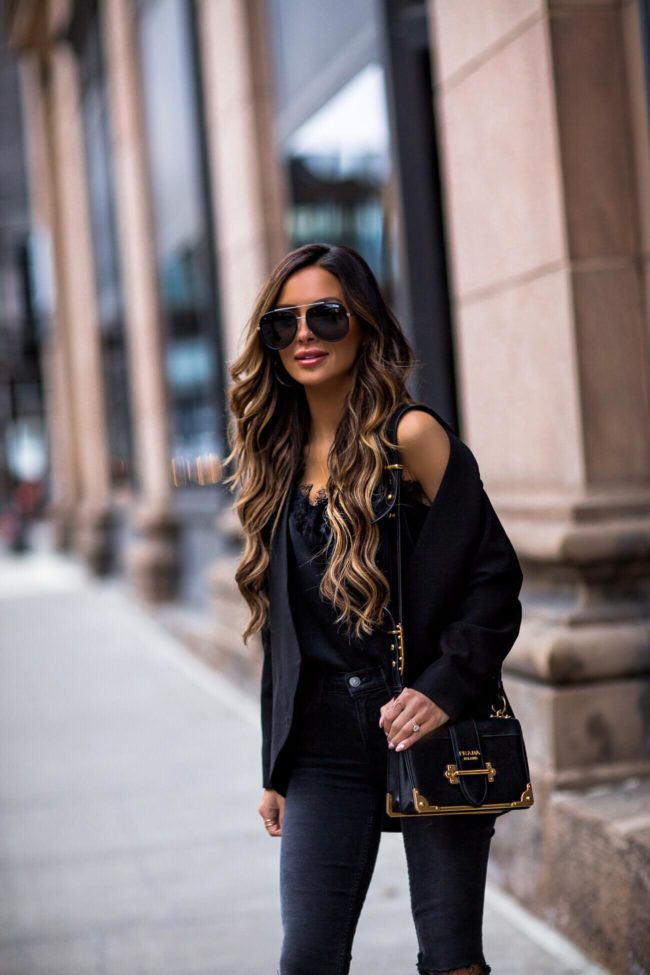 fashion blogger mia mia mine wearing a black blazer from revolve and a prada cahier bag
