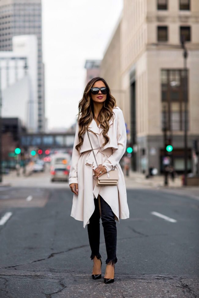 fashion blogger mia mia mine wearing an ivory trench coat from nordstrom and black christian louboutin heels