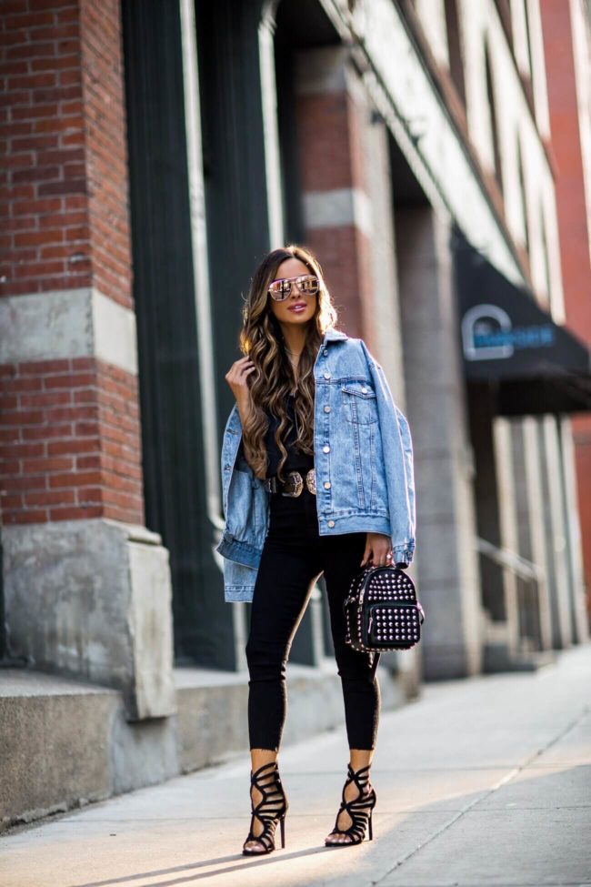 fashion blogger mia mia mine wearing a denim jacket and missguided heels