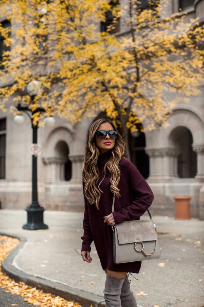 fashion blogger mia mia mine wearing a burgundy turtleneck sweater dress from H&M