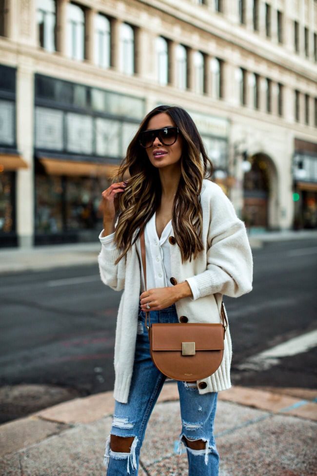 fashion blogger mia mia mine wearing a cardigan from revolve and a demellier bag