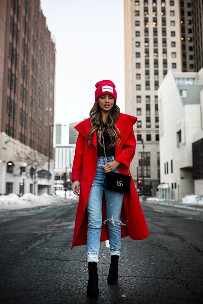 fashion blogger mia mia mine wearing a gucci bag and a red duster coat