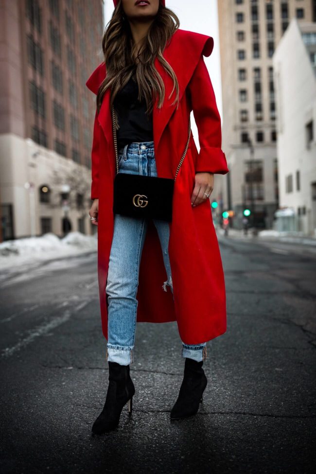 fashion blogger mia mia mine wearing a red duster coat and ann taylor black booties