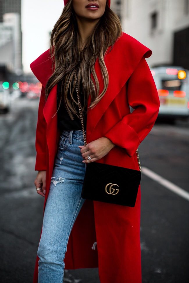fashion blogger mia mia mine wearing a gucci velvet bag and a red duster coat