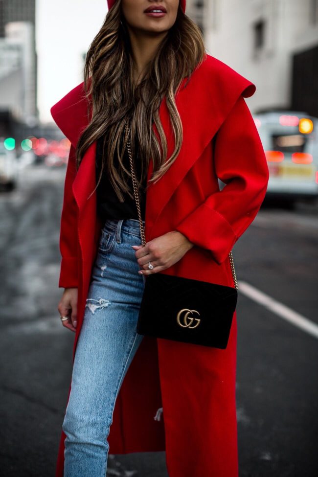 fashion blogger mia mia mine wearing a gucci velvet bag and a red duster coat