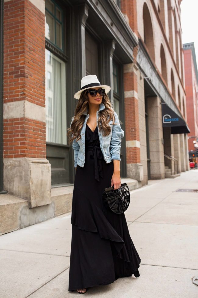 fashion blogger mia mia mine wearing a black maxi dress from walmart and a crop denim jacket