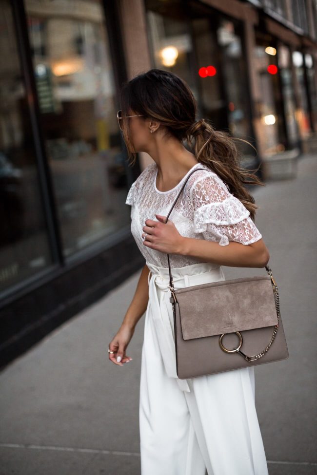 fashion blogger mia mia mine wearing a lace top and white trousers from walmart