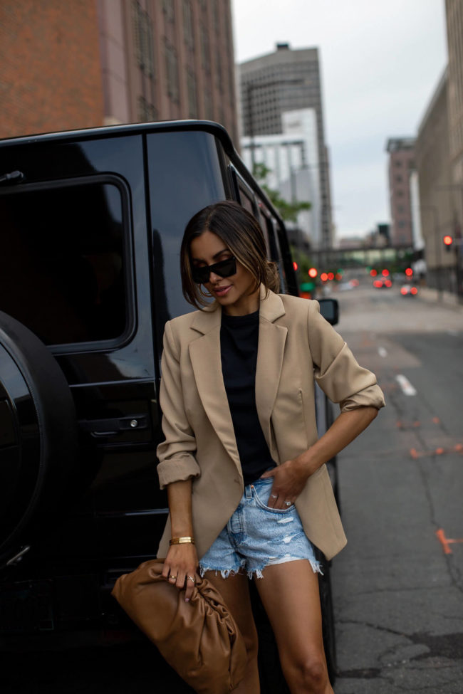 mia mia mine wearing an agolde black tee and levi's denim shorts from nordstrom