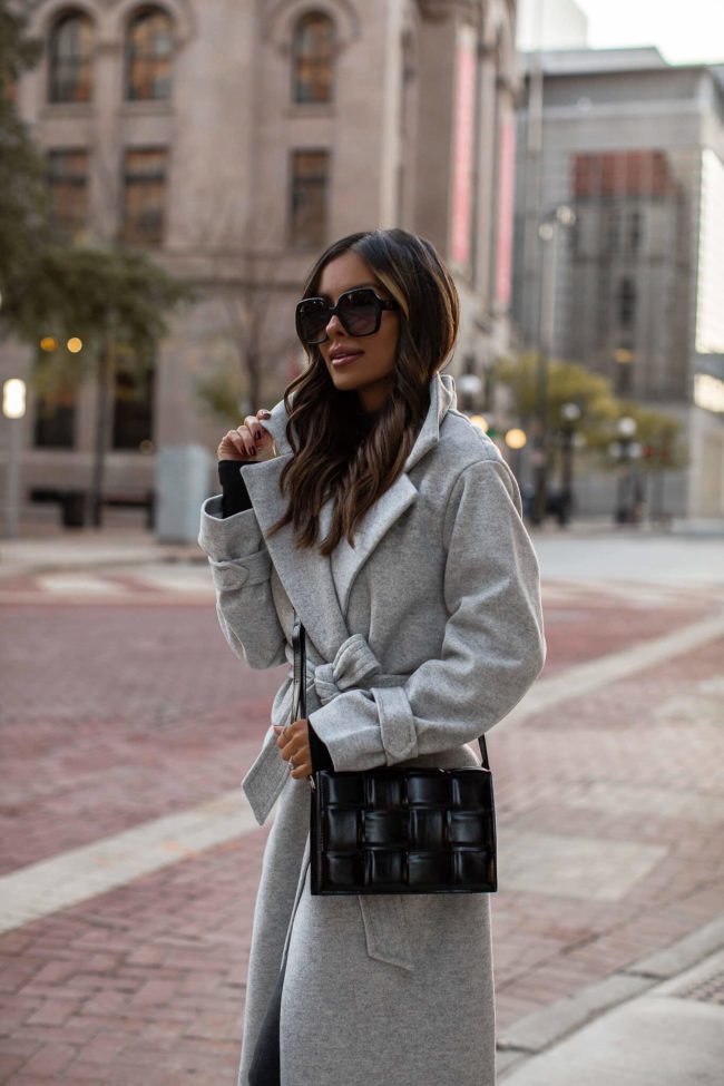 fashion blogger wearing gucci sunglasses and a gray coat