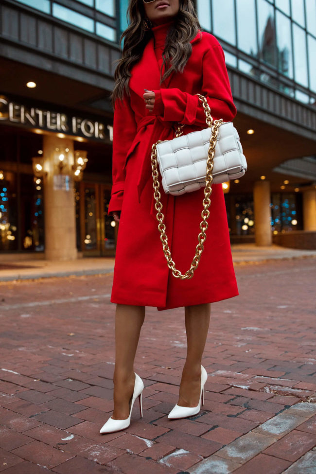 fashion blogger wearing a red wrap coat and red sweater dress from express