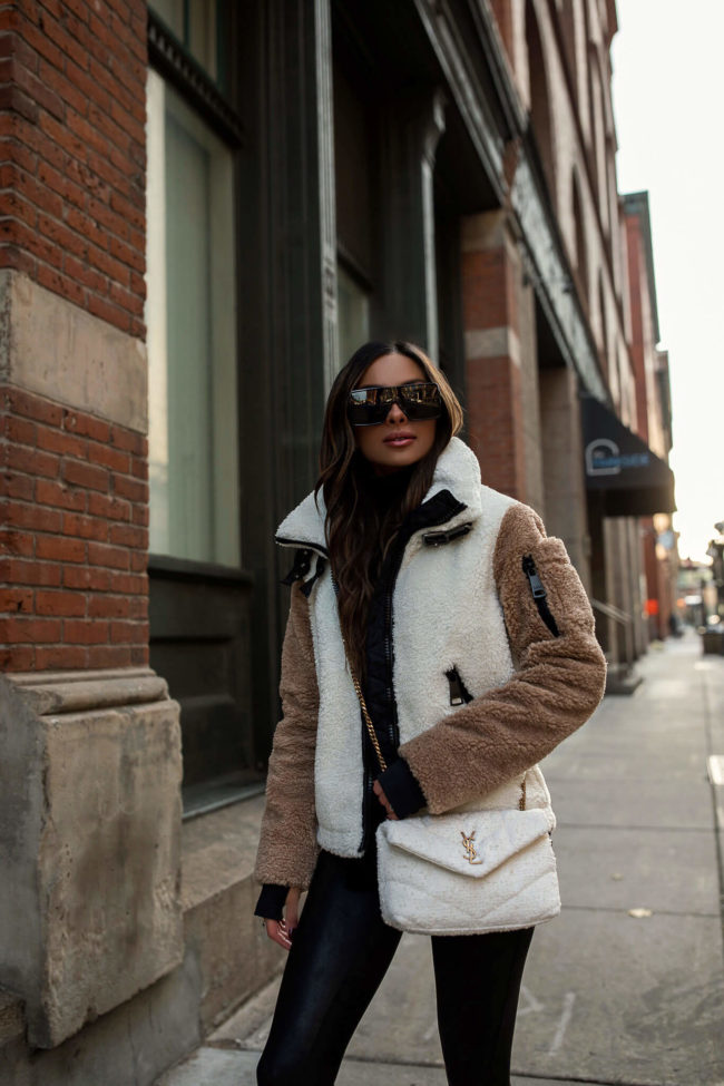 fashion blogger mia mia mine wearing a sherpa jacket and saint laurent toy puffer bag from saks fifth avenue