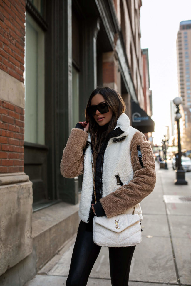 fashion blogger mia mia mine wearing a sherpa jacket by sam from saks fifth avenue