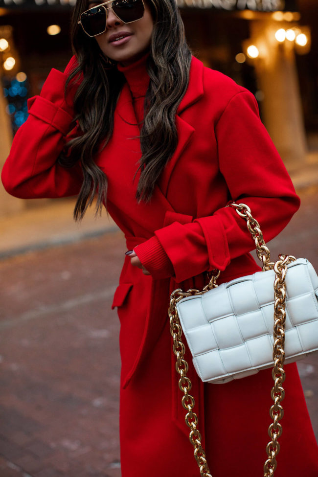 fashion blogger wearing a red wrap coat from express