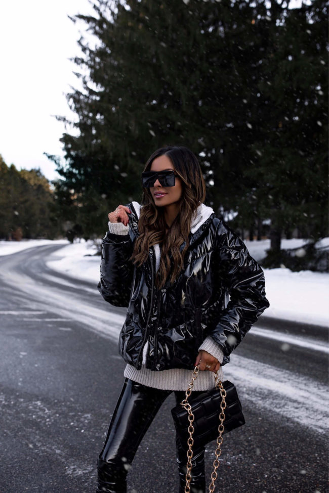 fashion blogger mia mia mine wearing a patent leather puffer jacket from walmart for winter
