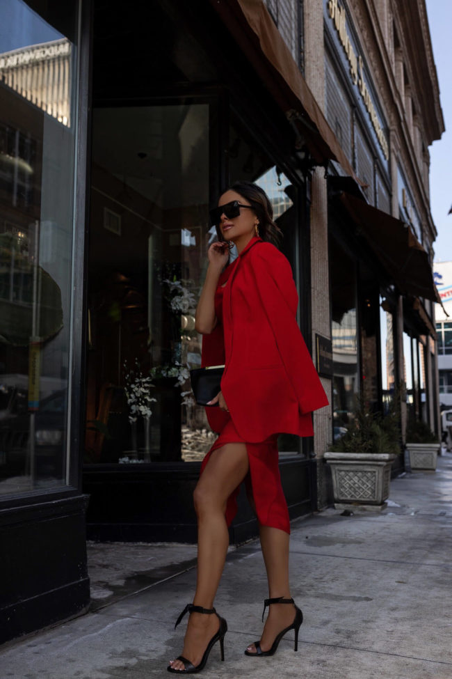 fashion blogger mia mia mine wearing a red satin dress and red blazer