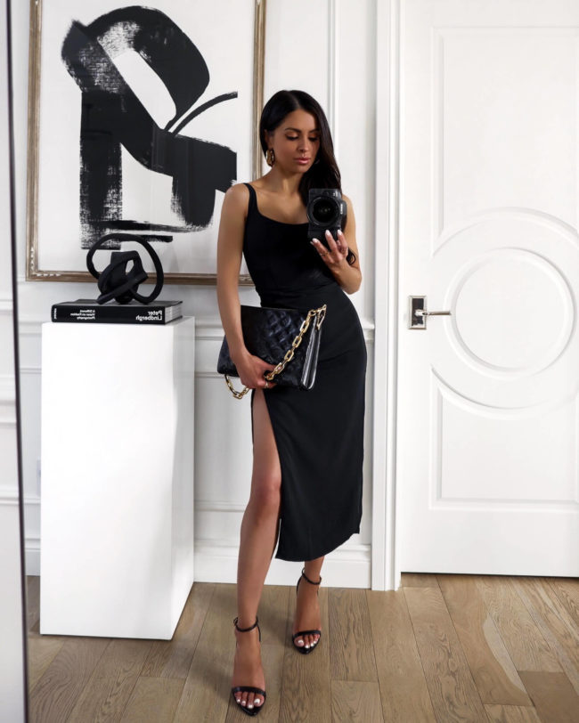 fashion blogger mia mia mine wearing a black slit dress from abercrombie