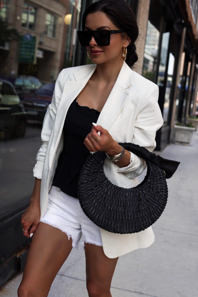 fashion blogger mia mia mine wearing a white linen blazer and a black straw bag from walmart