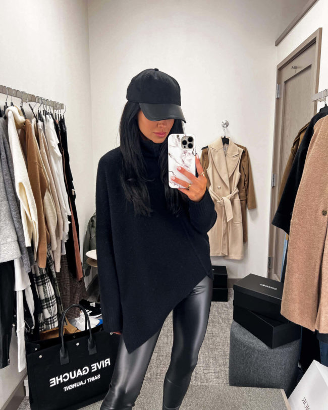fashion blogger mia mia mine wearing a black sweater from the nsale 2022