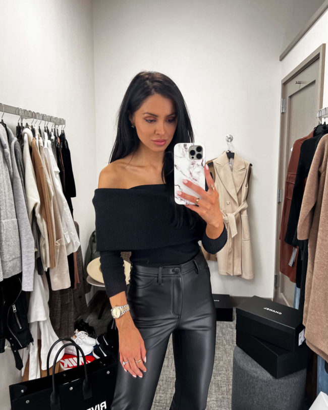 fashion blogger mia mia mine wearing a black off the shoulder top from the nsale 2022
