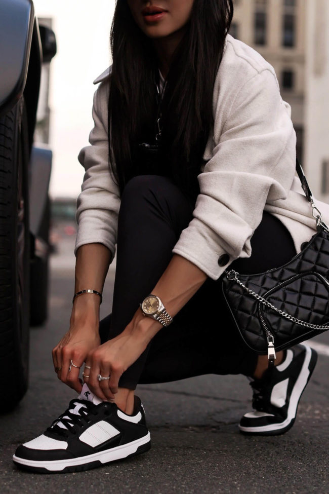 fashion blogger mia mia mine wearing black and white sneakers from walmart