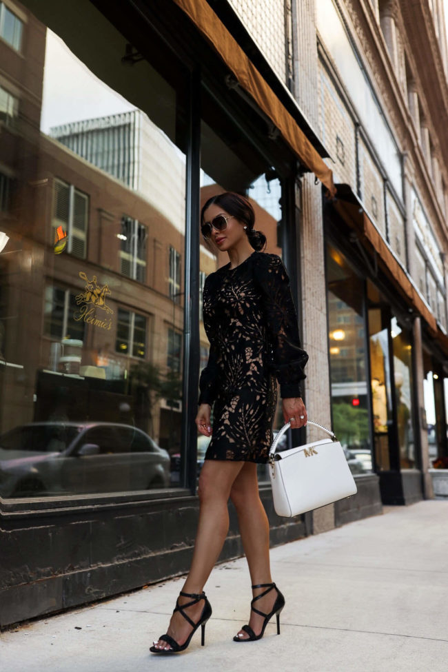 fashion blogger wearing a black lace mini dress by michael kors