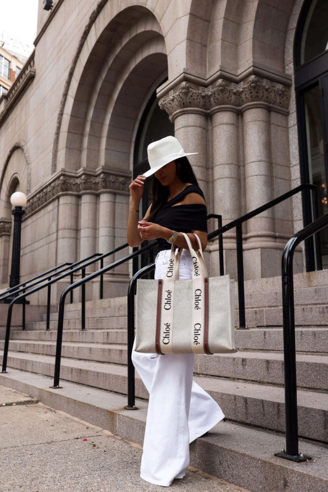 fashion blogger mia mia mine wearing a chloe woody tote and black bodysuit from saks