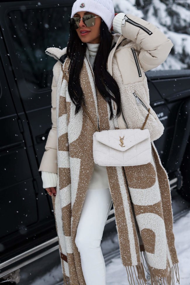 fashion blogger mia mia mine wearing a white winter outfit from saks