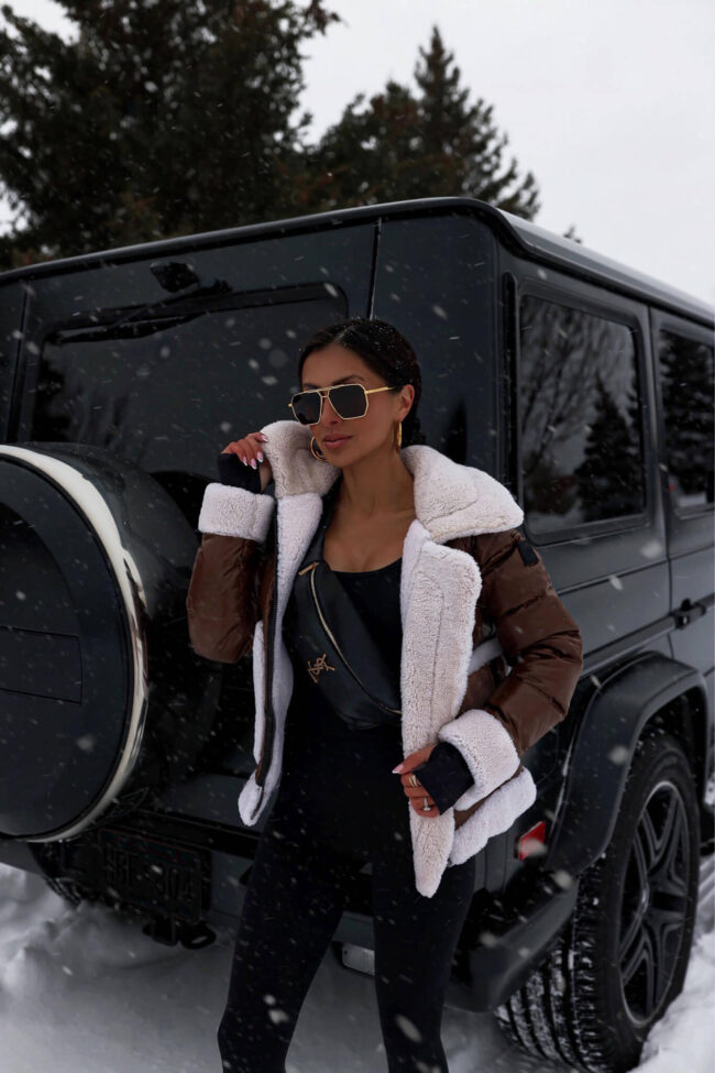 fashion blogger mia mia mine wearing a brown shearling jacket and a saint laurent belt bag