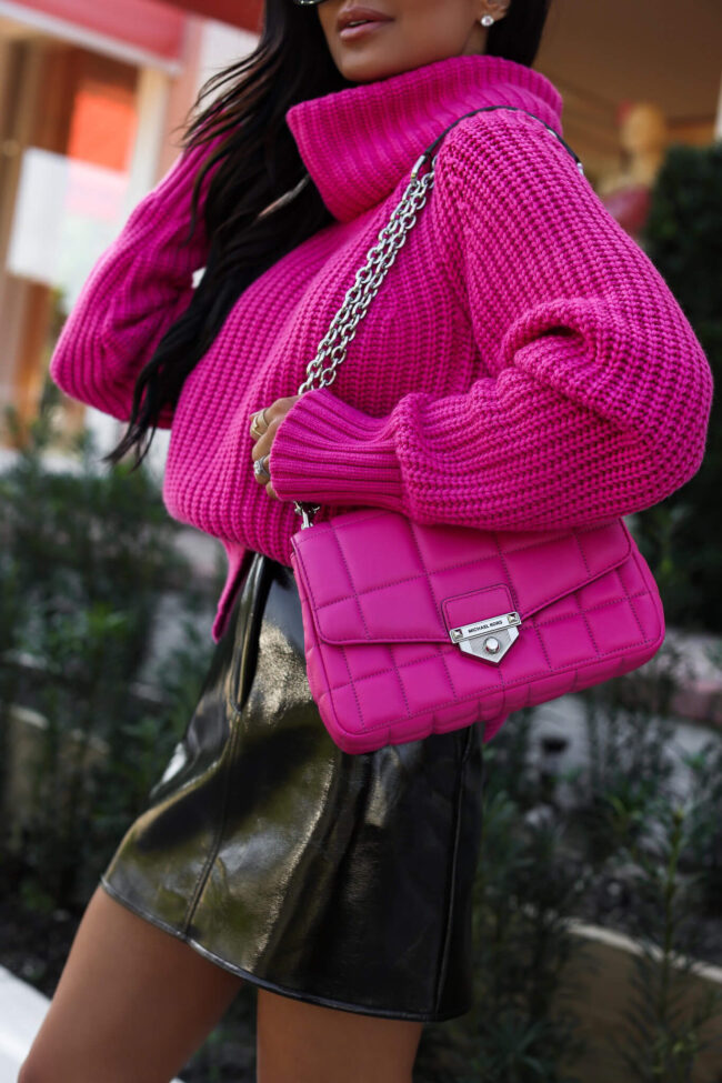 fashion blogger wearing a hot pink michael kors soho bag