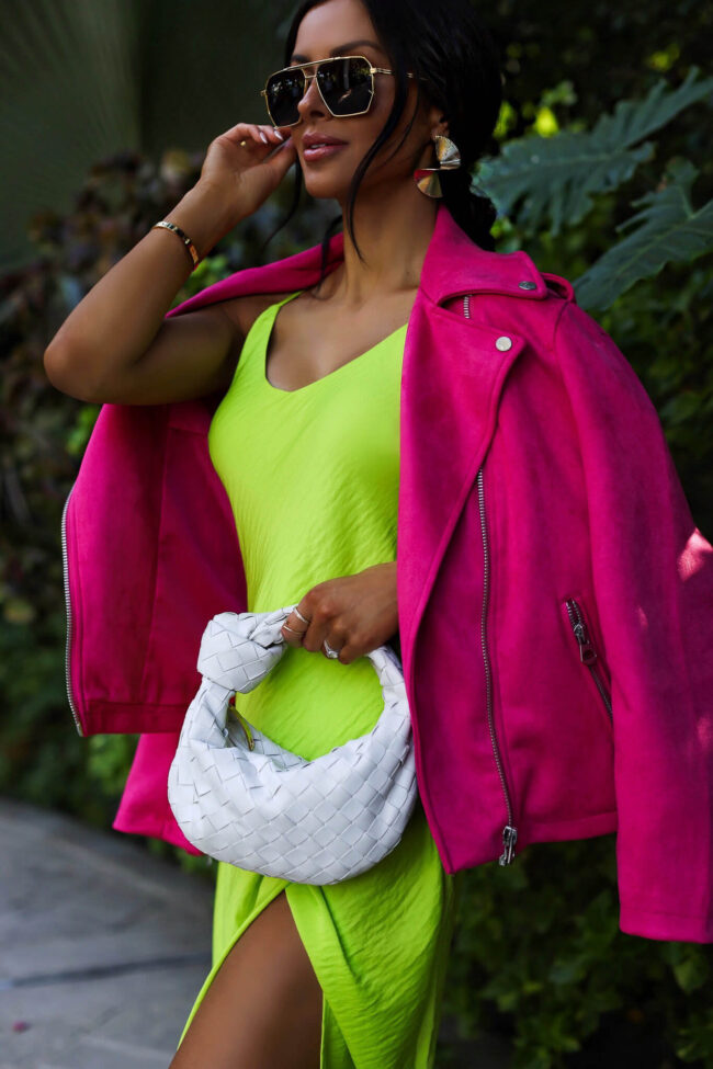 fashion blogger wearing a lime green dress with a pink jacket