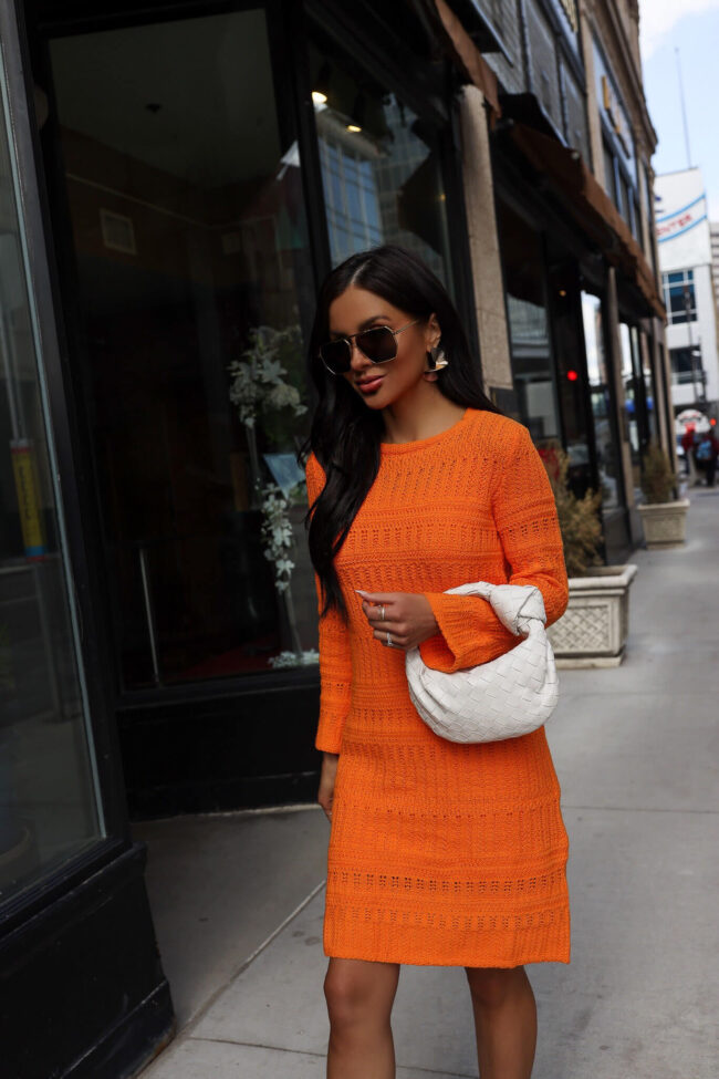 fashion blogger wearing an orange mini dress from walmart