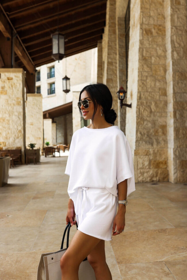 fashion blogger wearing a white sweatsuit by frank & eileen