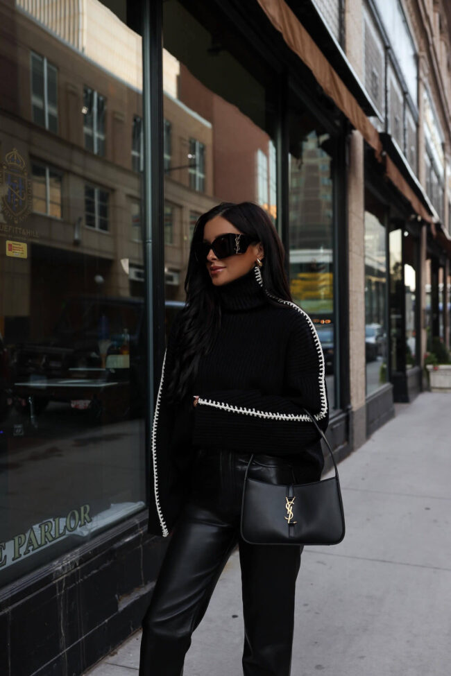 fashion blogger wearing a black and white stitched sweater by rag & bone