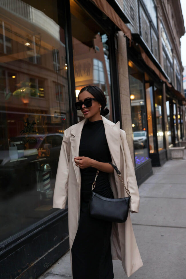 fashion blogger mia mia mine wearing a black dress and a trench coat from walmart