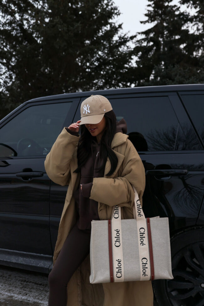 fashion blogger mia mia mine wearing a good american puffer robe coat and a brown nike sweatsuit from nordstrom