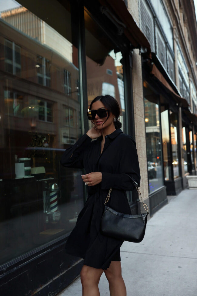 fashion blogger wearing a black spring dress