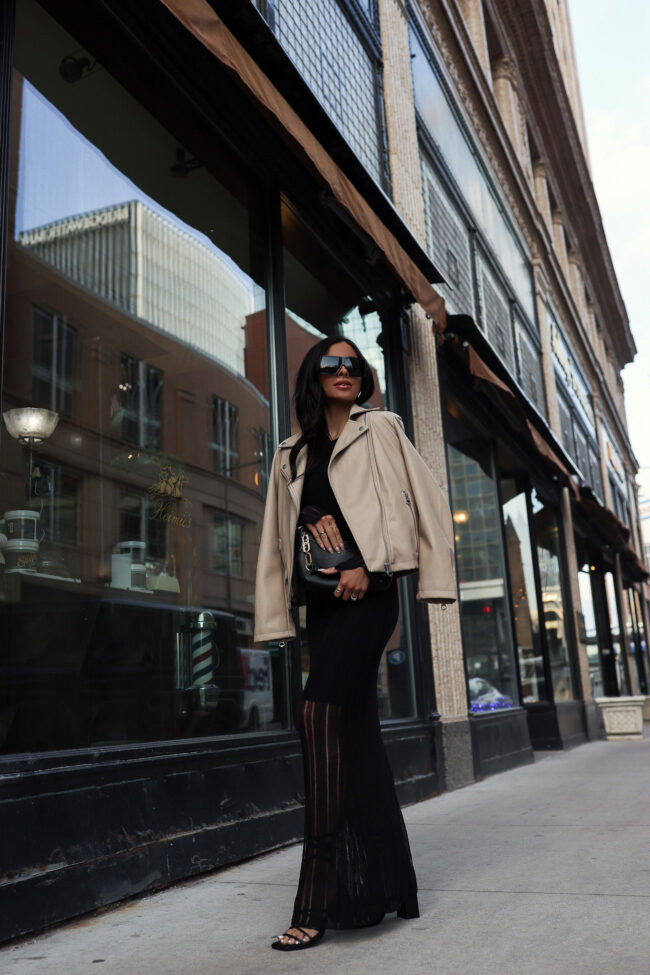 fashion blogger mia mia mine wearing a tan faux leather jacket and a black midi dress from walmart