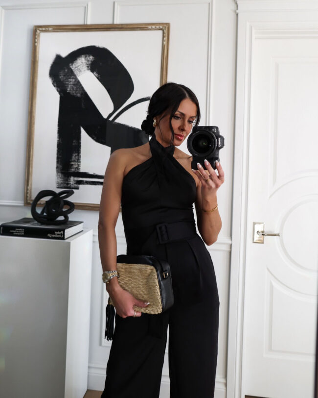 fashion blogger wearing a black satin jumpsuit from walmart