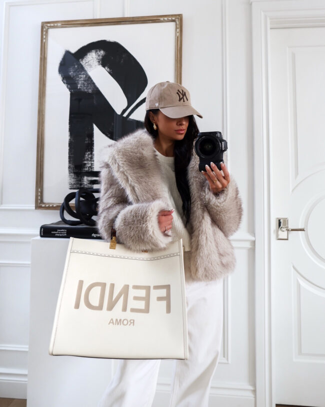 brunette fashion blogger wearing a gray faux fur coat by free people