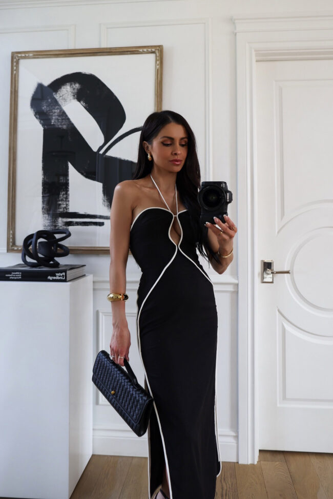 brunette fashion blogger wearing a black and white dres