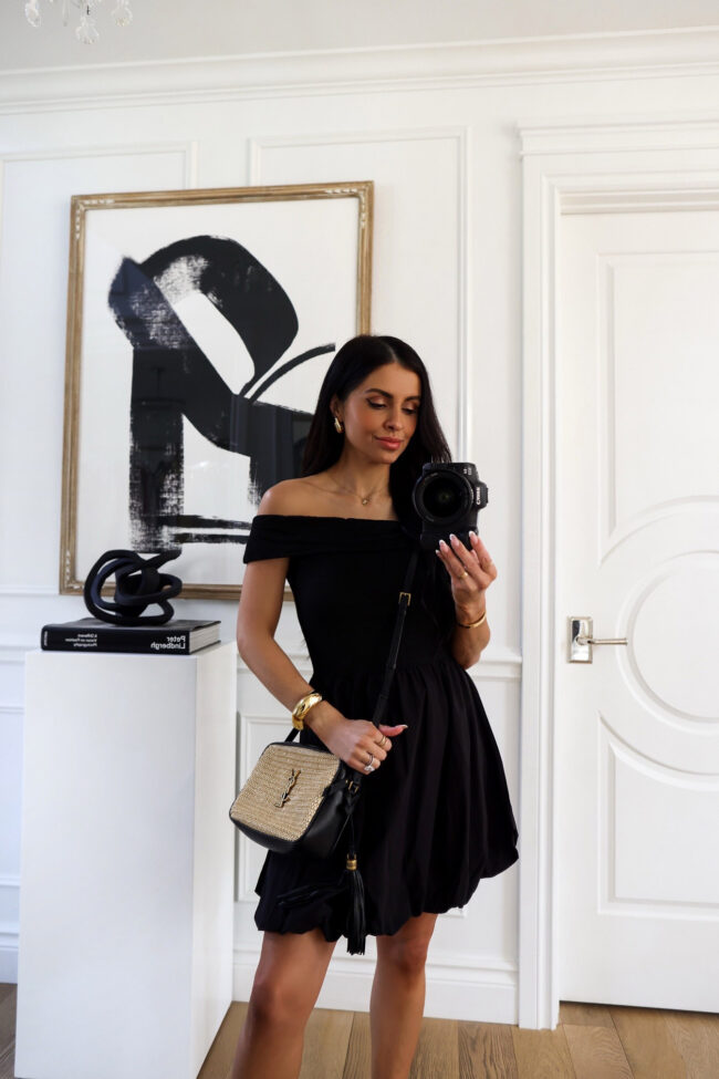 mia mia mine wearing a black summer dress