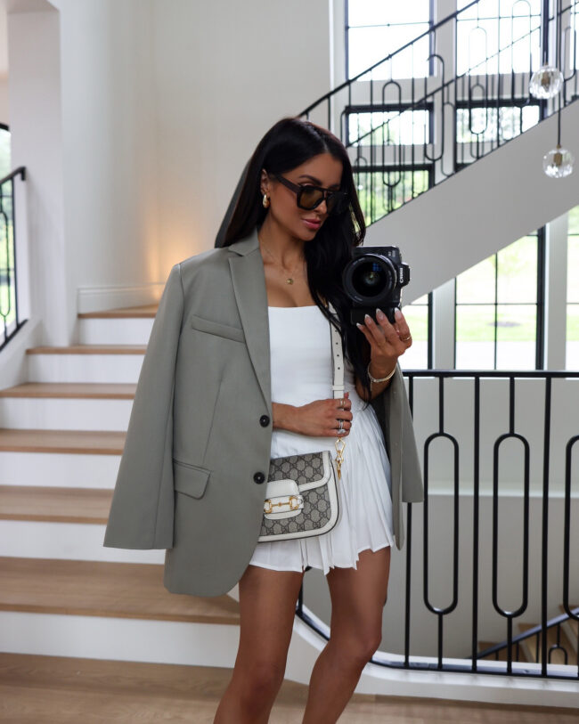 mia mia mine wearing an oversized blazer and tennis dress for summer