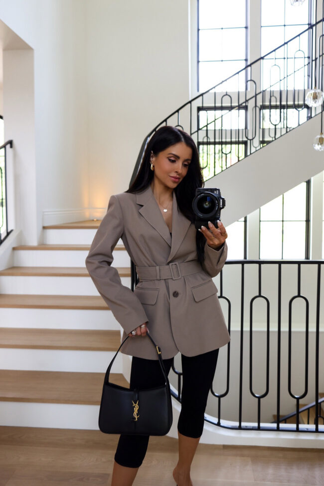 mia mia mine wearing an oversized belted blazer from wayf