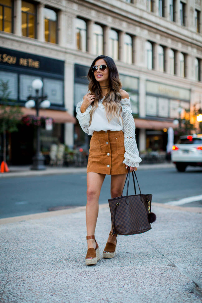 fashion blogger mia mia mine wearing a white off-the-shoulder lace top from shopbop and a suede skirt