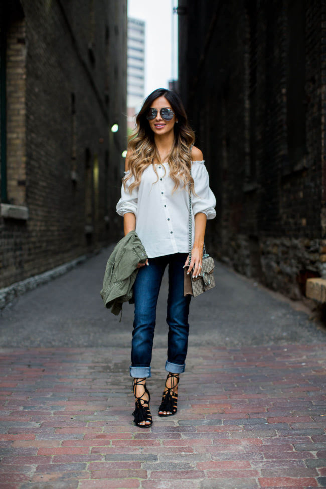 fashion blogger mia mia mine wearing an off-the-shoulder new york & company top