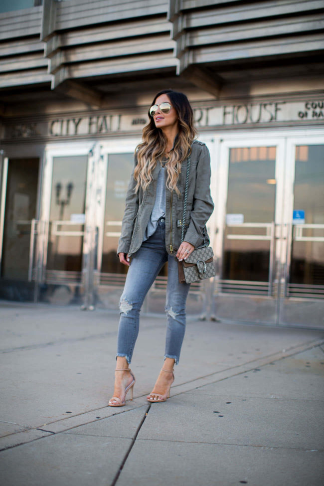 mia mia mine wearing a studded utility jacket by sanctuary and gray jeans from express