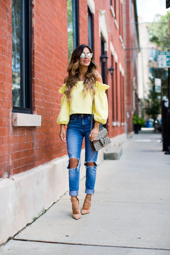 fashion blogger mia mia mine in chicago in a yellow off-the-shoulder top from shopbop