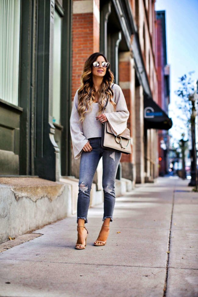 fashion blogger mia mia mine wearing a free people sweater and grey jeans from express
