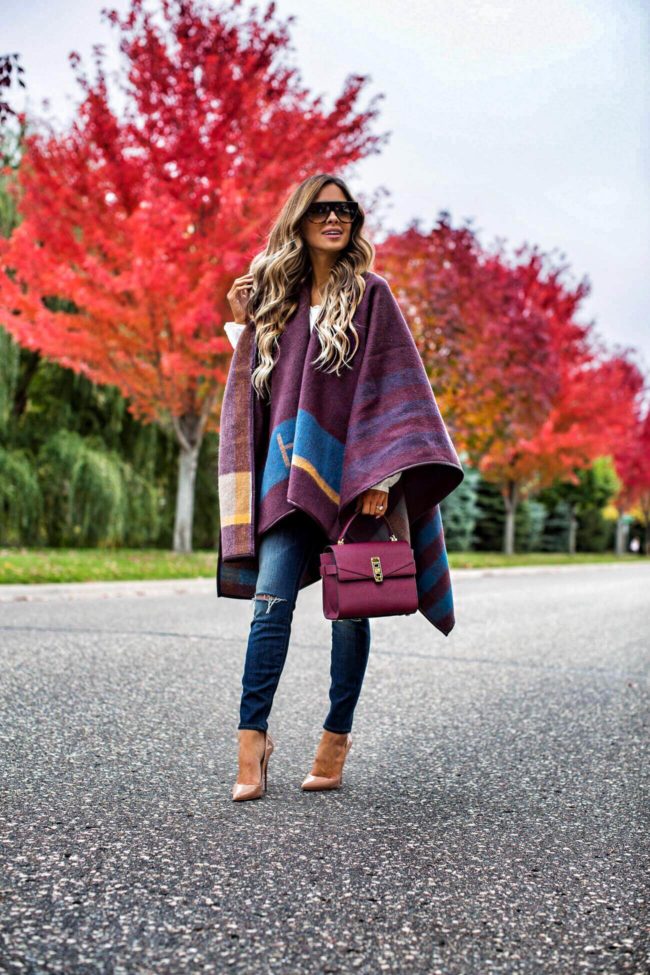 fashion blogger mia mia mine carrying a burgundy henri bendel bag